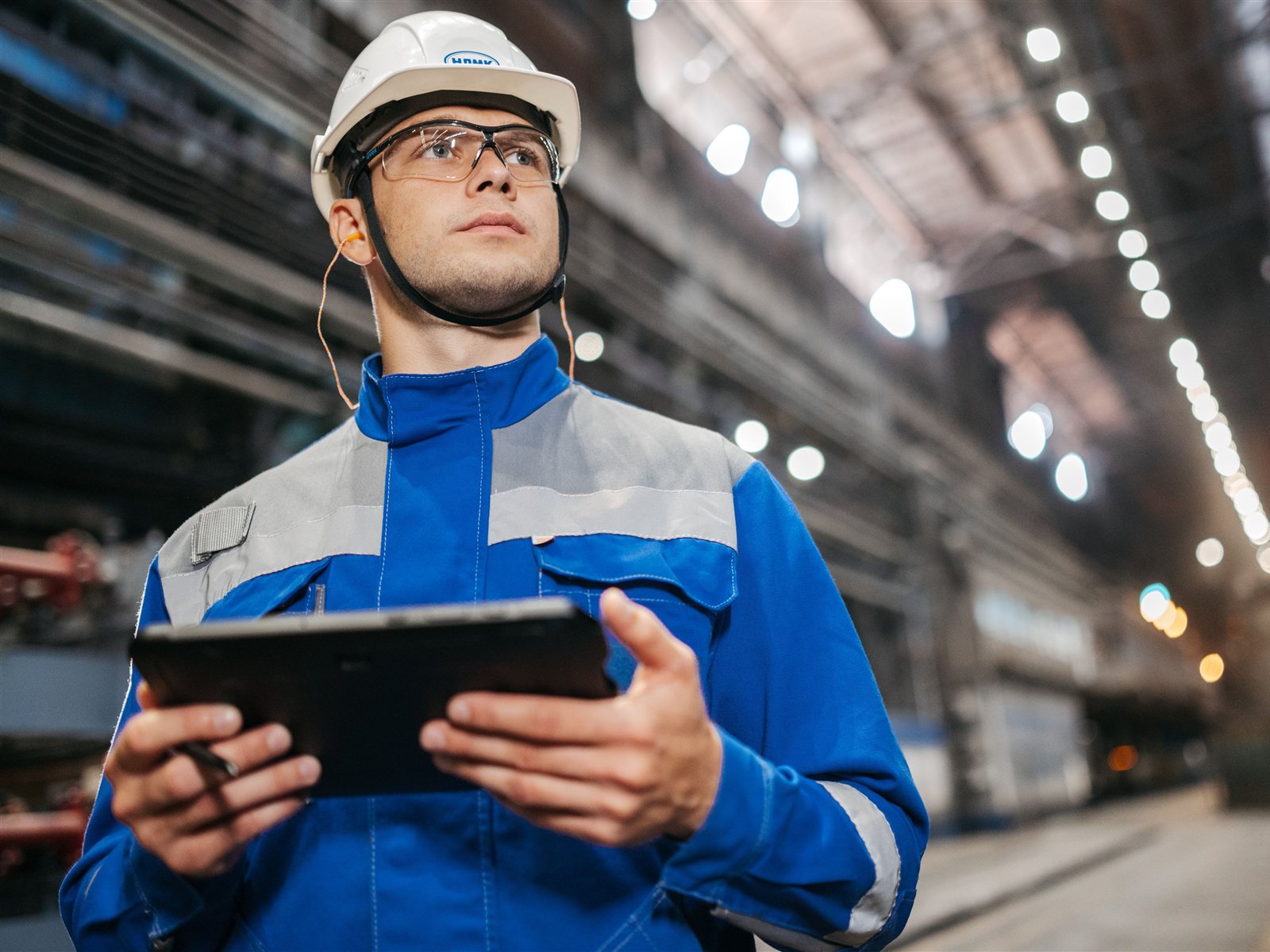 Ingeniero con tablet revisando una planta industrial